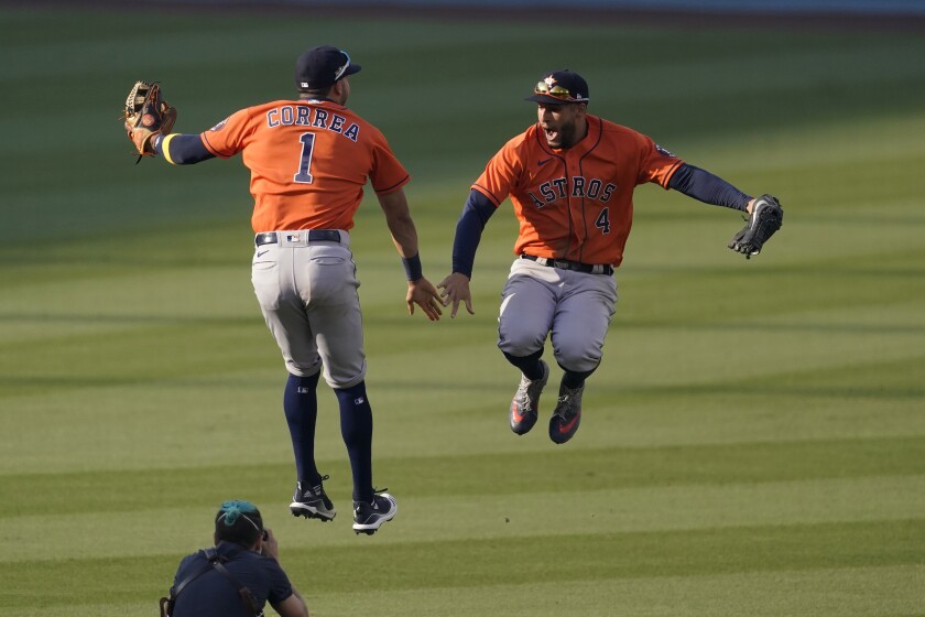 Houston Astros' Carlos Correa celebrates with George Springer.