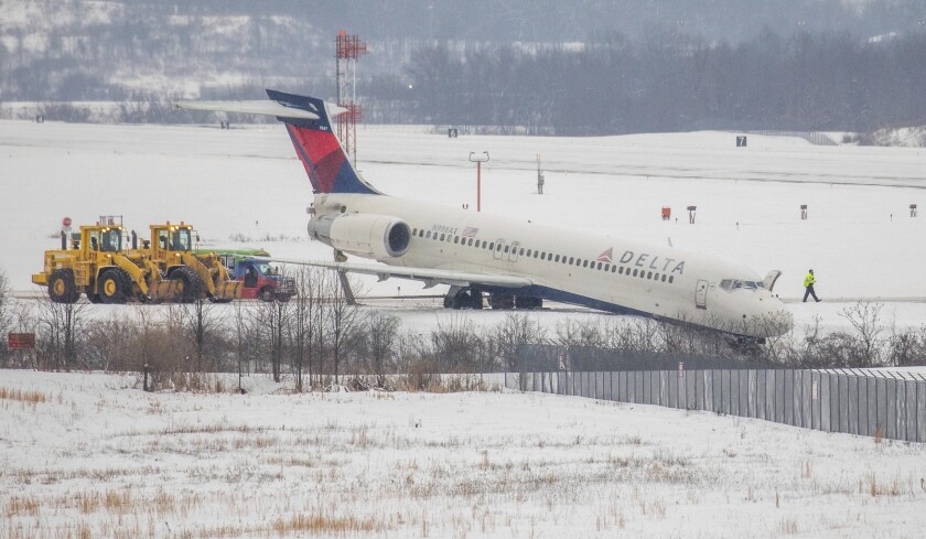 A Delta airplane stuck in a large ditch at Pittsburgh International Airport on Thursday, Feb. 11, 2021 in Moon Township. The Boeing 717 was departing for Atlanta with 77 people on board when it "exited a taxiway" just prior to takeoff near a runway. (Andrew Rush/Pittsburgh Post-Gazette via AP)