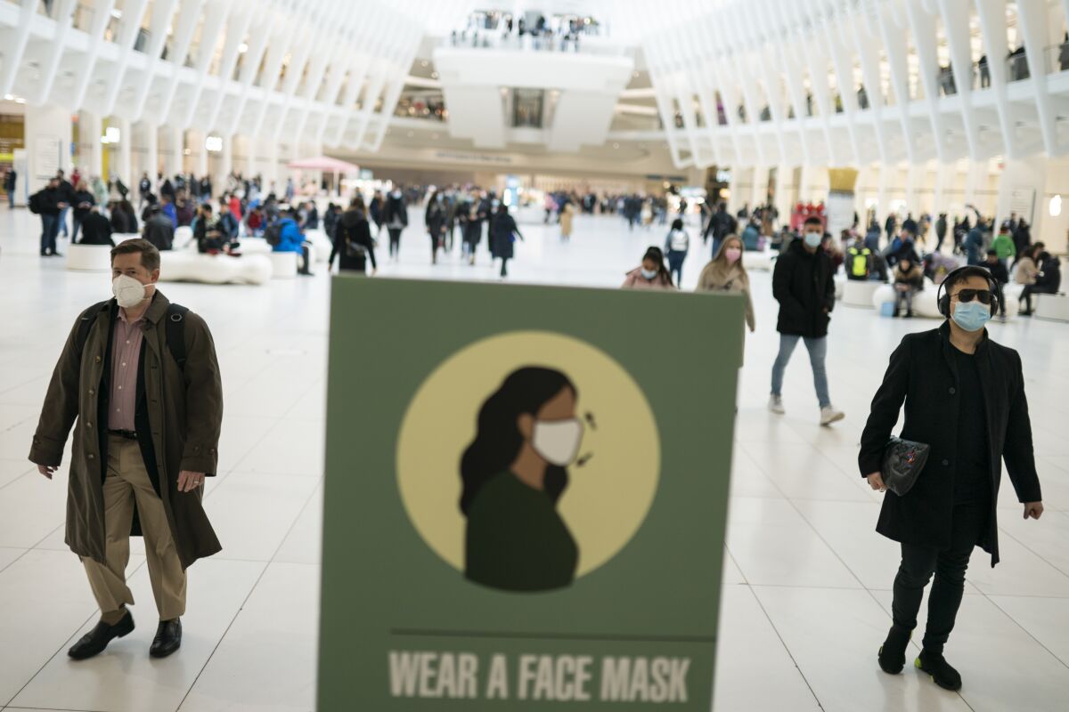 Mass transit riders wear masks as they commute in the financial district of lower Manhattan.