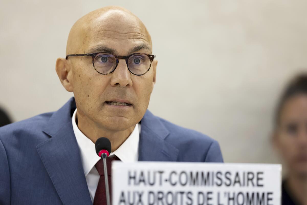 U.N. High Commissioner for Human Rights Volker Türk wears a suit and speaks into a microphone.