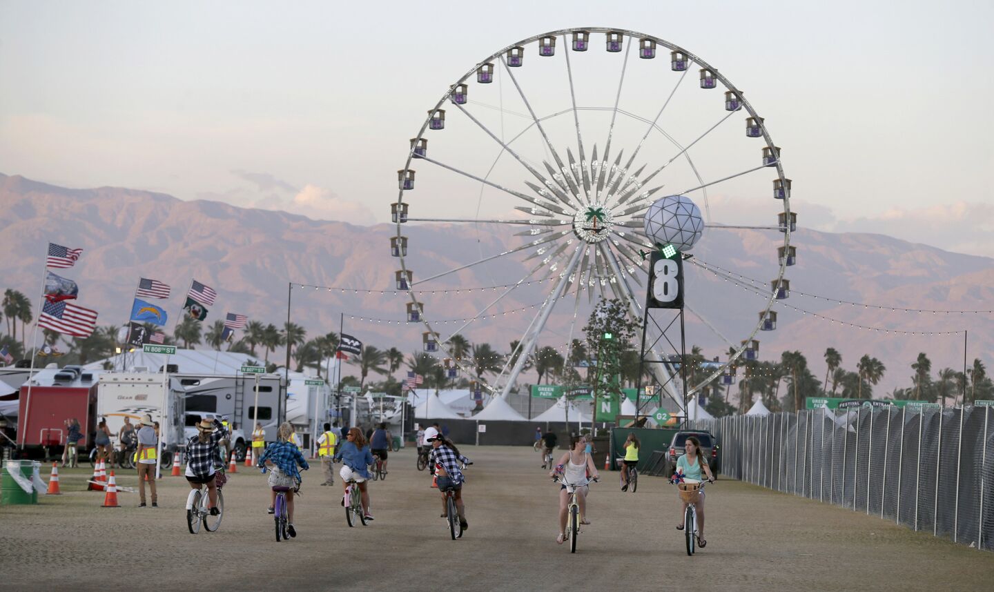 Country music fans ride bikes at dusk at the Stagecoach Country Music Festival.