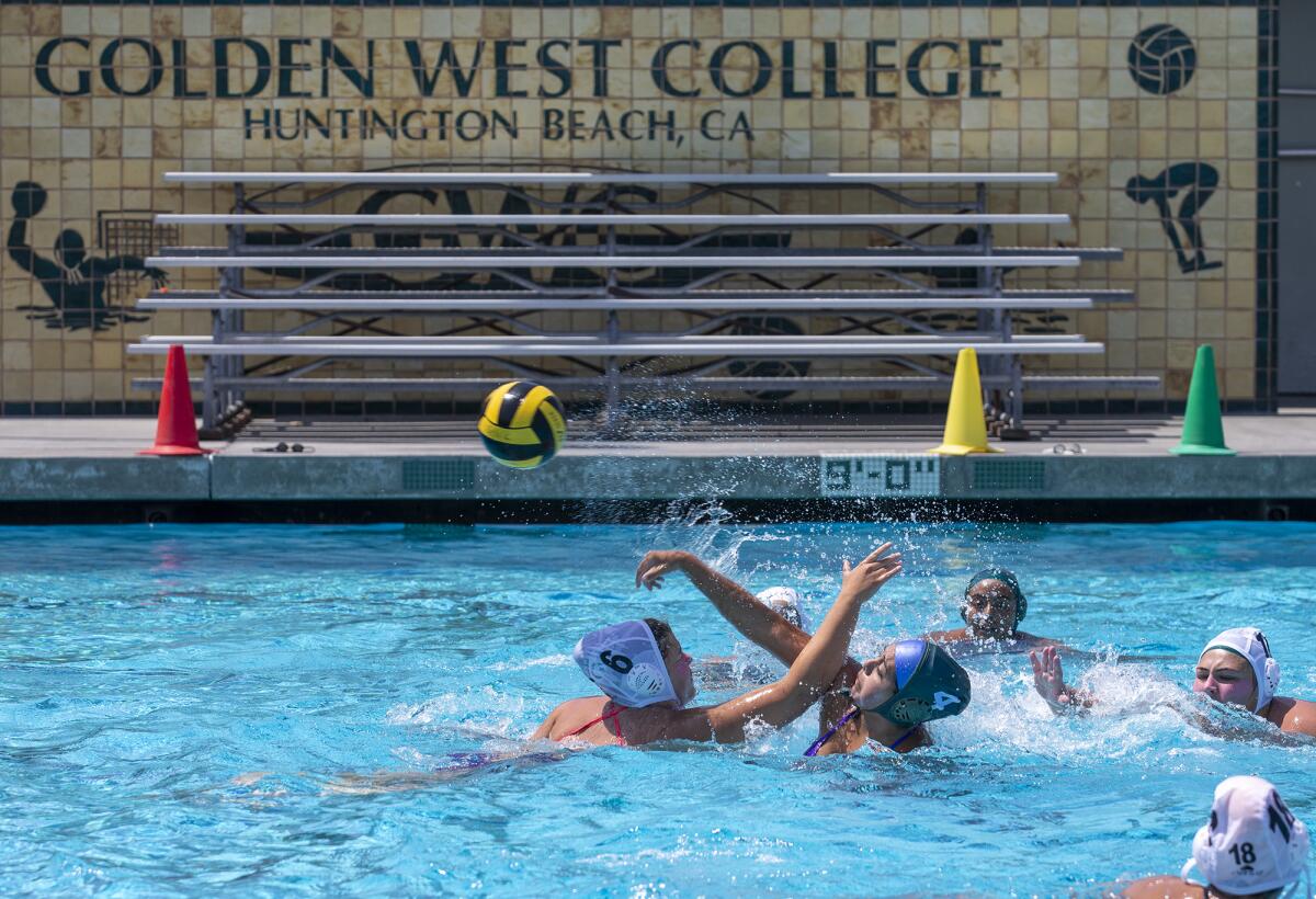 The Golden West College girls' water polo team practices during the first day of classes on Monday.