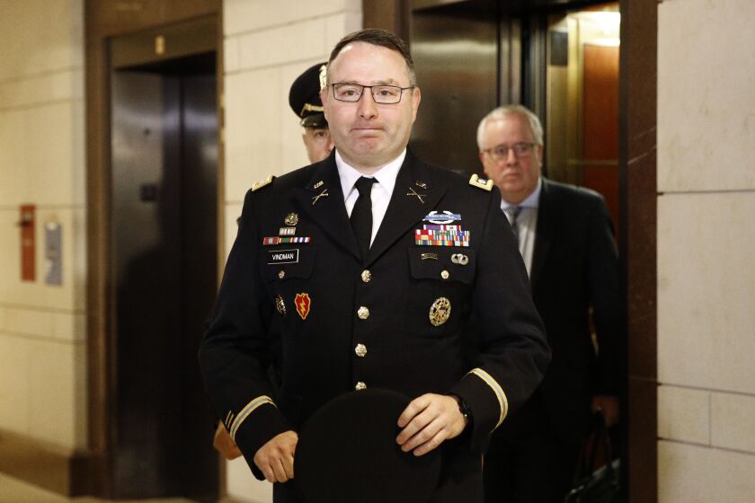 Army Lieutenant Colonel Alexander Vindman, a military officer at the National Security Council, center, arrives on Capitol Hill in Washington, Tuesday, Oct. 29, 2019, to appear before a House Committee on Foreign Affairs, Permanent Select Committee on Intelligence, and Committee on Oversight and Reform joint interview with the transcript to be part of the impeachment inquiry into President Donald Trump.(AP Photo/Patrick Semansky)