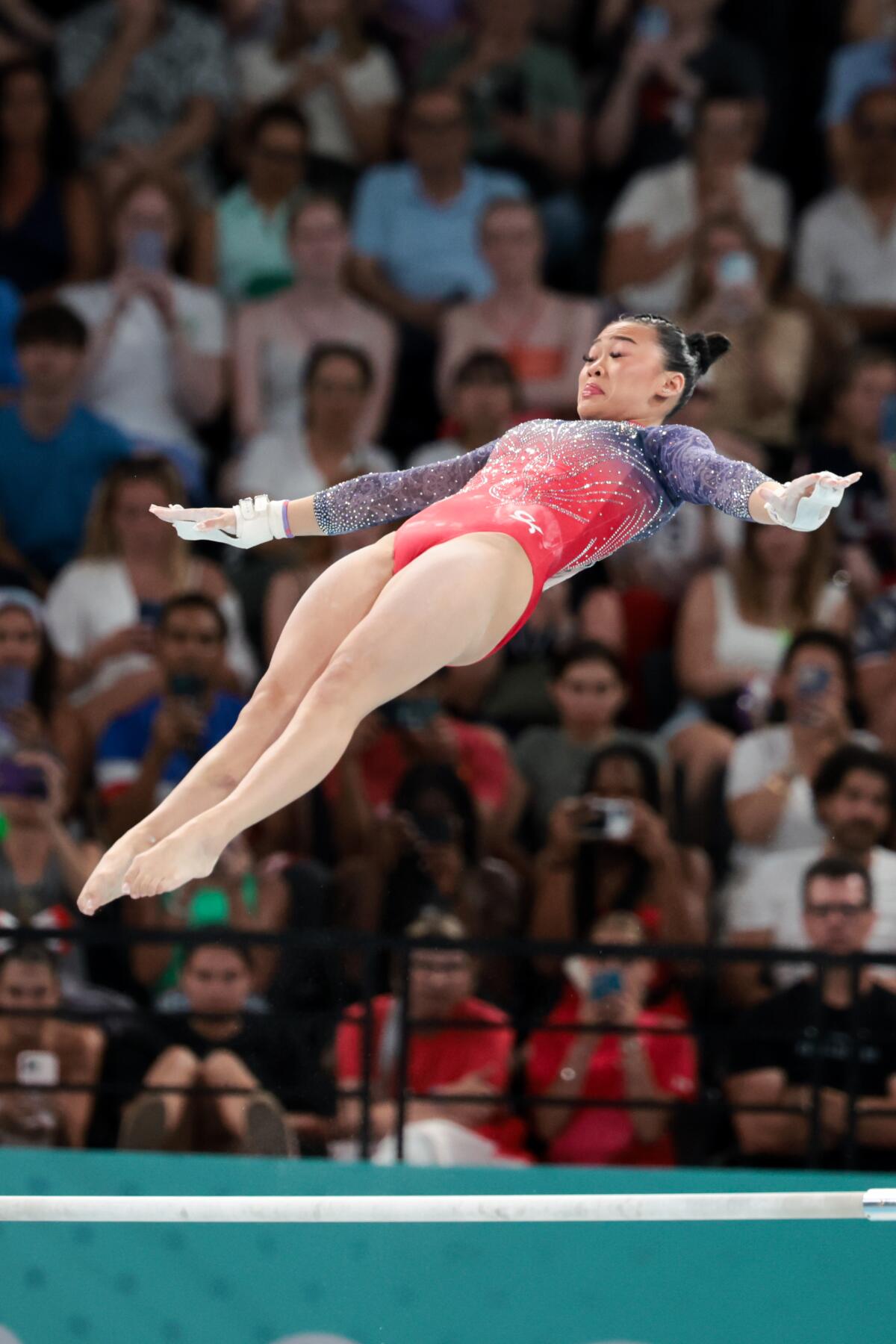 Suni Lee competes on the uneven bars during the women's all-around gymnastic final at the 2024 Summer Olympics Thursday.