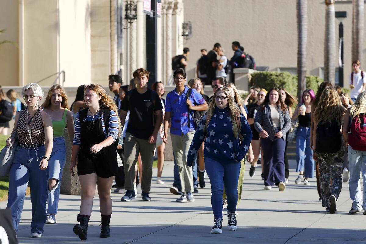 Students make their way to class after the first bell at Huntington Beach High on Wednesday.