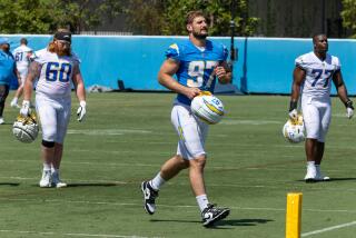 Joey Bosa (97) walks off the Chargers' practice field.