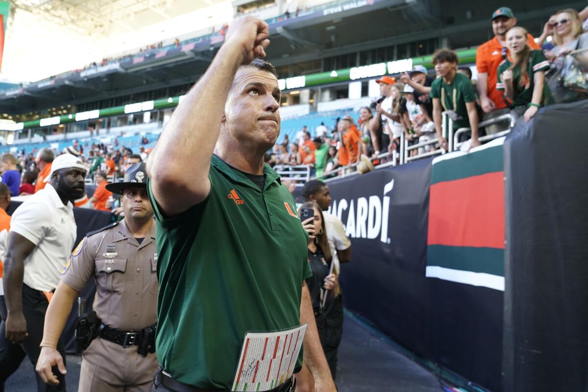 Miami coach Mario Cristobal pumps his fist after winning in his Hurricanes debut.