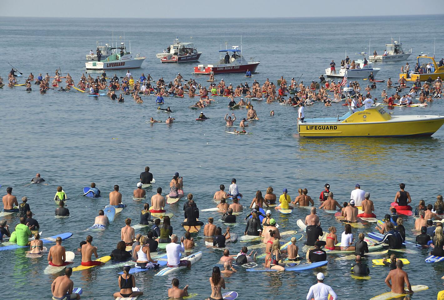 Hundreds of people gather to remember Newport Beach lifeguard Ben Carlson on Sunday.