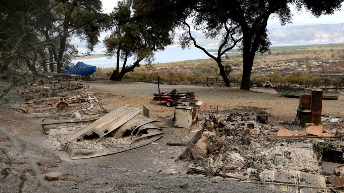 The remains of a structure and boats scorched by the Whittier fire in Los Padres National Forest near Lake Cachuma.