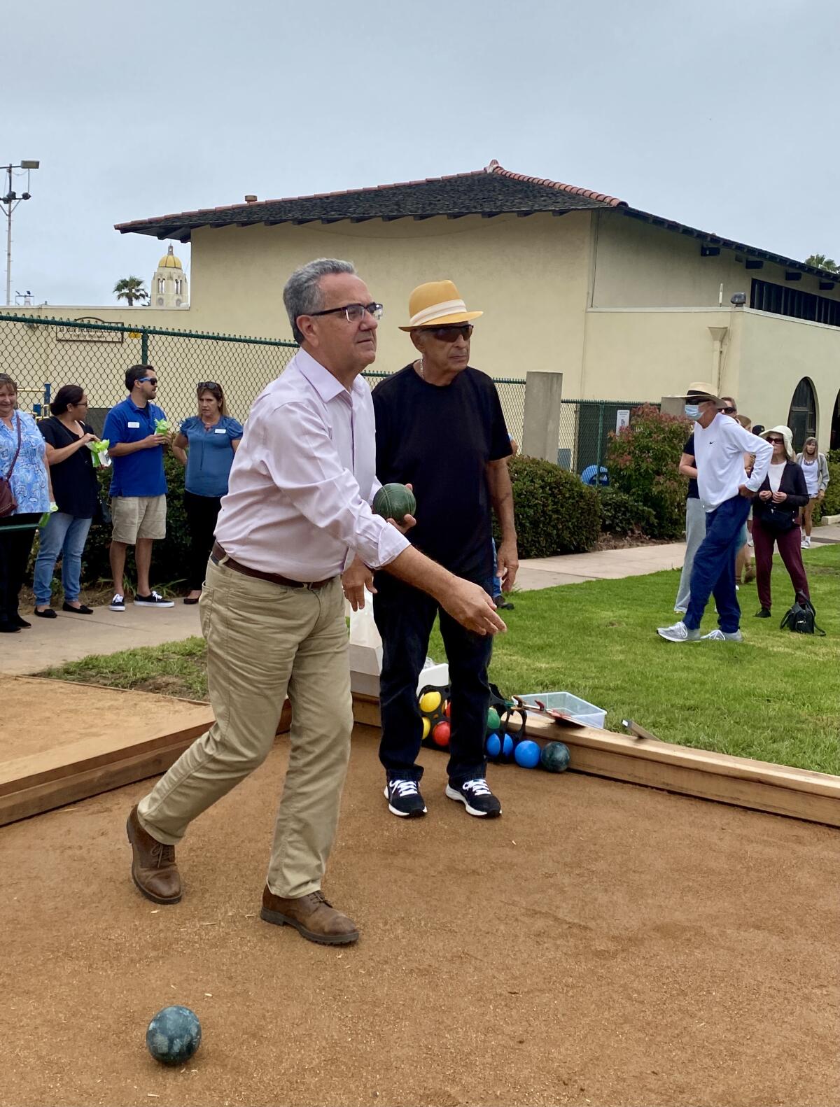 San Diego Councilman Joe LaCava (left) throws out the first bocce ball June 30 on the La Jolla Recreation Center's new court.