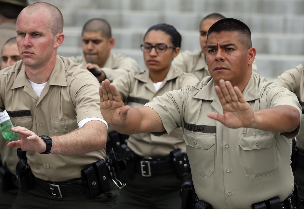 Los Angeles County sheriff's recruits go through a drill on their first day of training in Monterey Park. Union officials say low pay is hindering efforts to recruit qualified sheriff's applicants.