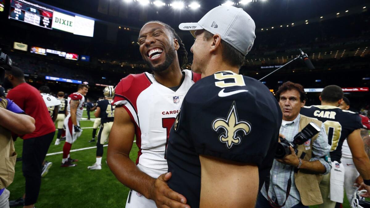 Arizona Cardinals wide receiver Larry Fitzgerald and New Orleans Saints quarterback Drew Brees are in reach to break legendary records this season.