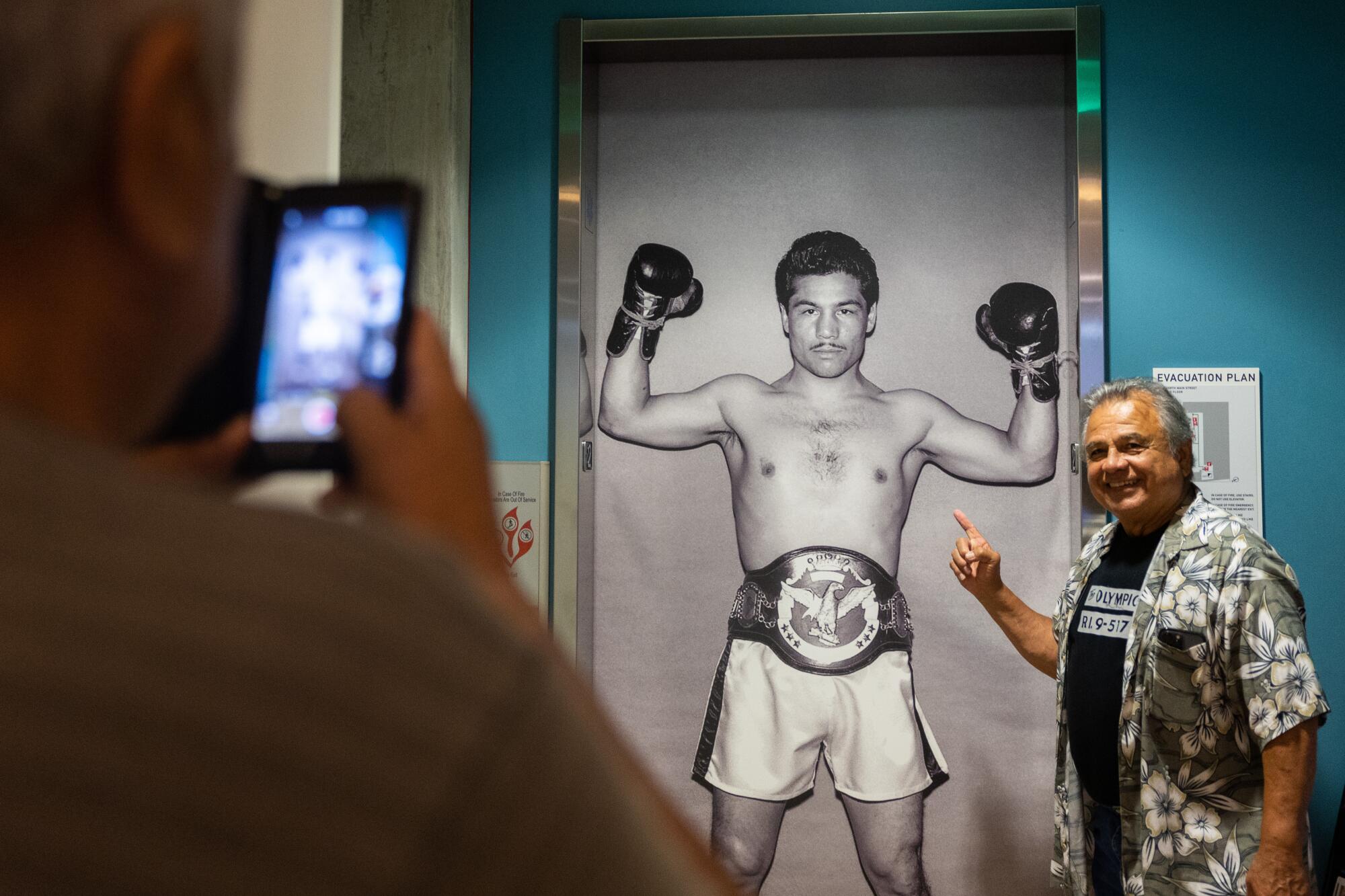Ruben Lucero, 73, takes a photo during the the "18th & Grand: The Olympic Auditorium" exhibit at LA Plaza de Cultura y Artes