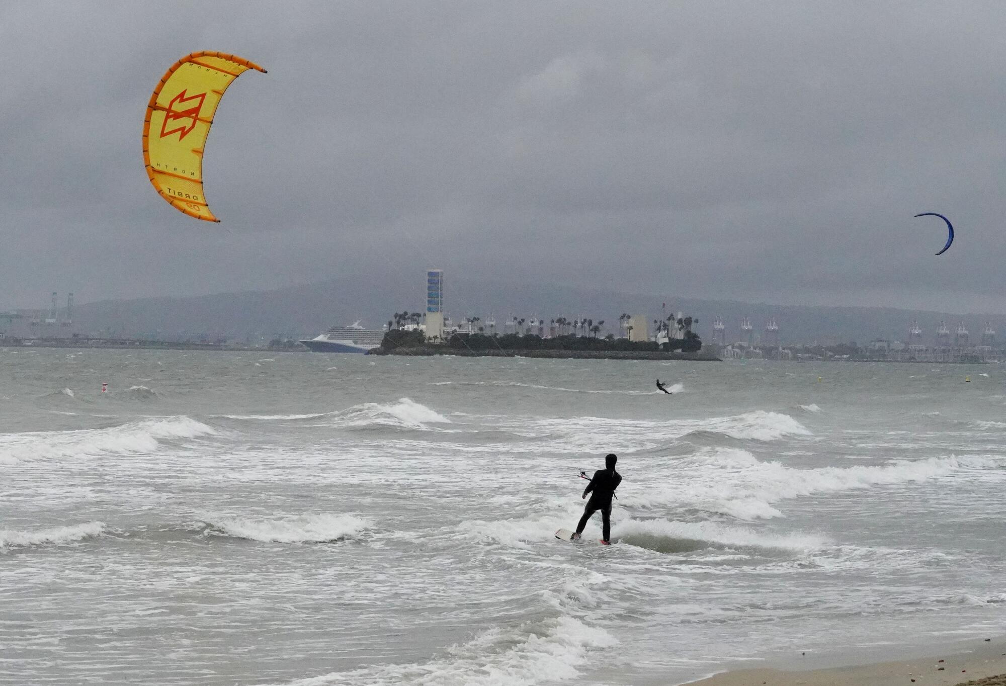 A kitesurfer launches a yellow kite at Belmont Shore in Long Beach 