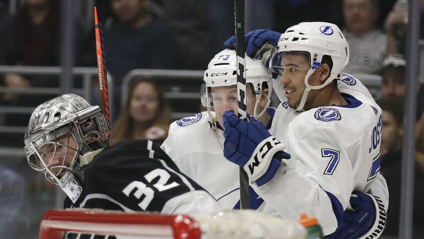 Tampa Bay Lightning's Mathieu Joseph (7) celebrates his goal with teammate Adam Erne, center, next to Kings goaltender Jonathan Quick, left, during the third period.