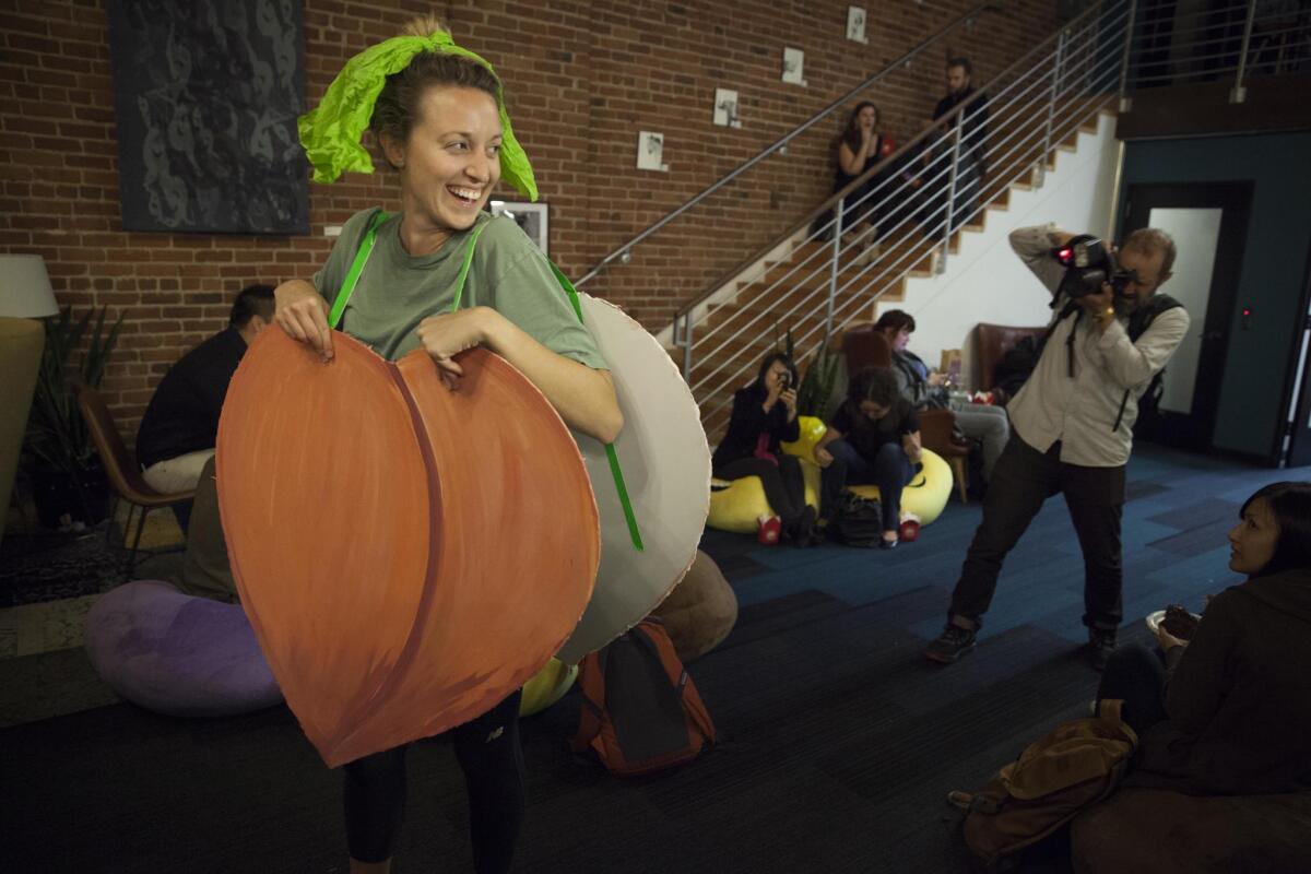 Alli McKee dressed as an old Apple peach emoji costume in protest of the company's recent move to make its peach look less like a posterior. She wore it to the Emojicon launch party at Covo a co-working space in San Francisco, CA, USA.