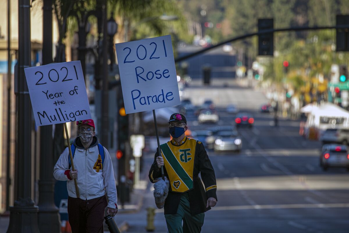 Curtis McKendrick, 26, left, and  his father Robert McKendrick, 60, make their own 2021 Rose Parade march 