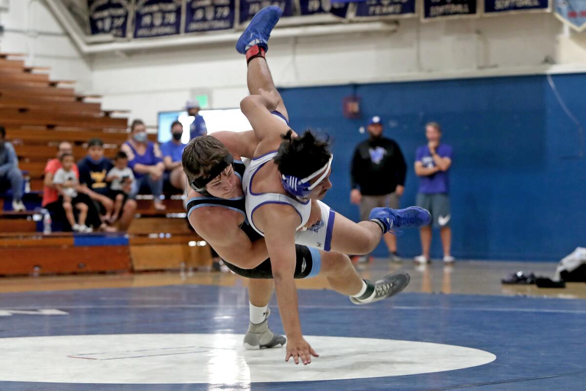 Corona del Mar's Dylan Wood, left, drops Western's Juan Orozco-Garcia to the mat during the 182-pound match on Saturday.