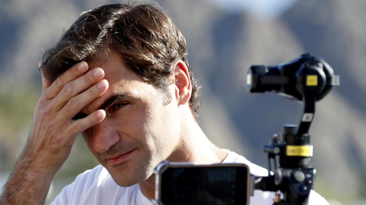 Roger Federer wipes his brow as he talks to reporters during media day at Indian Wells Tennis Garden on Wednesday.
