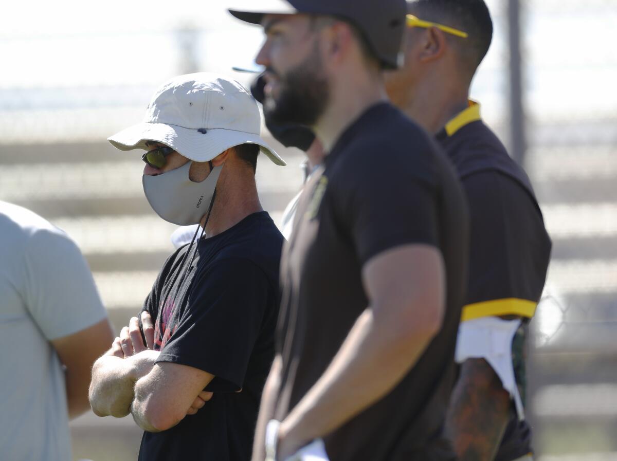 Padres GM A.J. Preller looks on during a spring training practice in Peoria, Ariz.