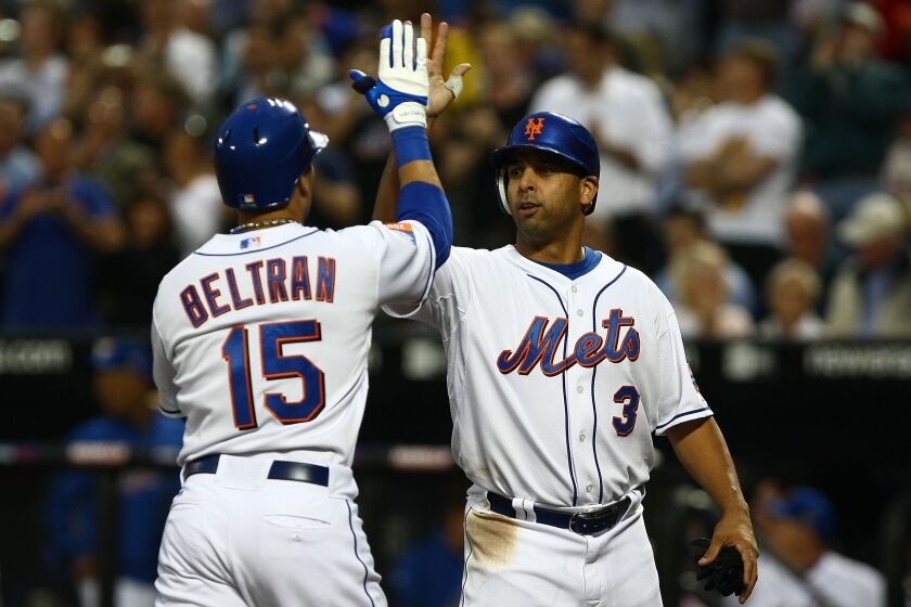 NEW YORK - JUNE 09: Alex Cora #3 of the New York Mets congratulates team mate Carlos Beltran #15 after he hit a home run against the Philadelphia Phillies during their game at Citi Field on June 9, 2009 in the Flushing neighborhood of the Queens borough of New York City. (Photo by Chris McGrath/Getty Images)