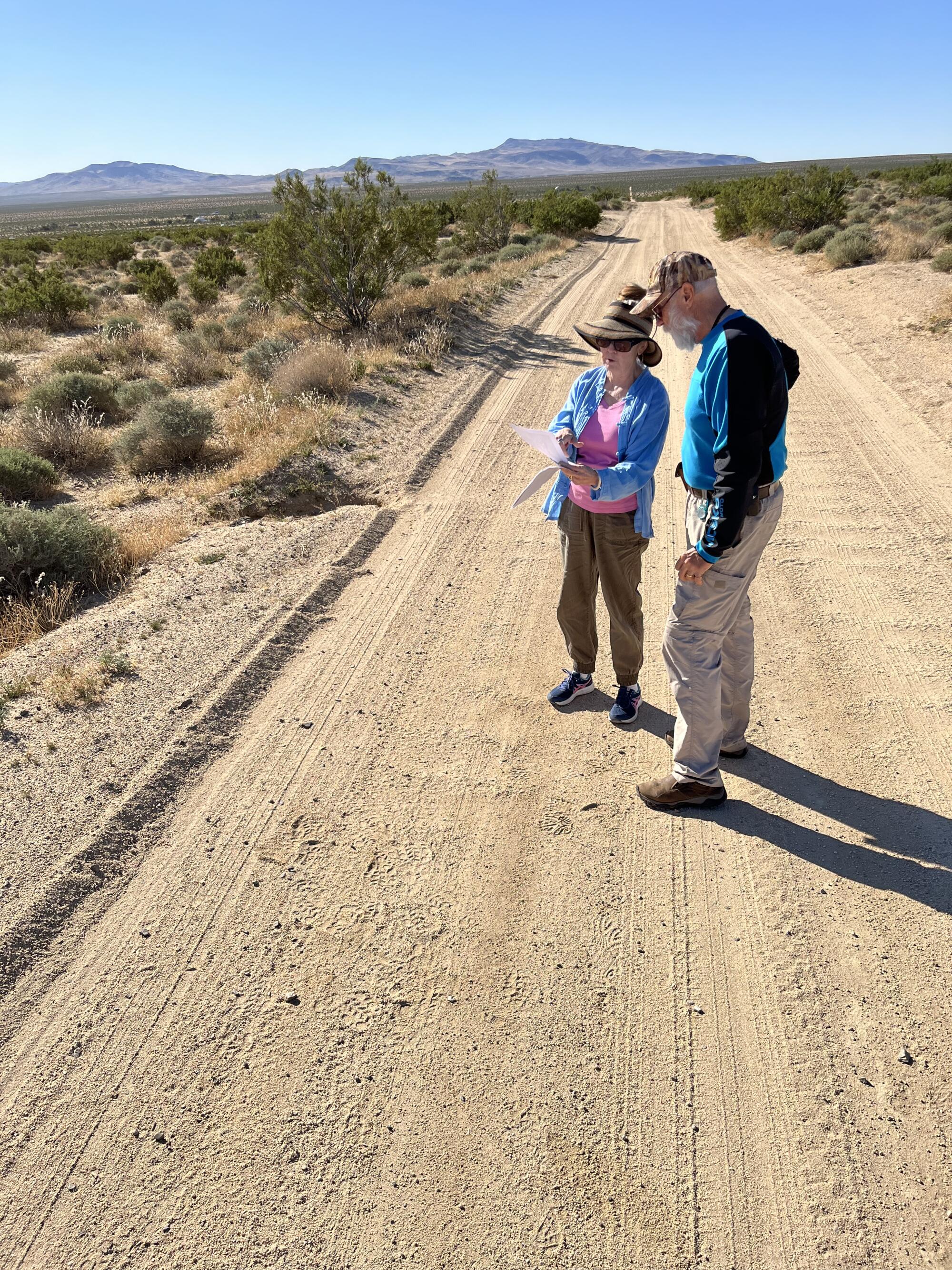Two people standing on a dirt road in Ridgecrest
