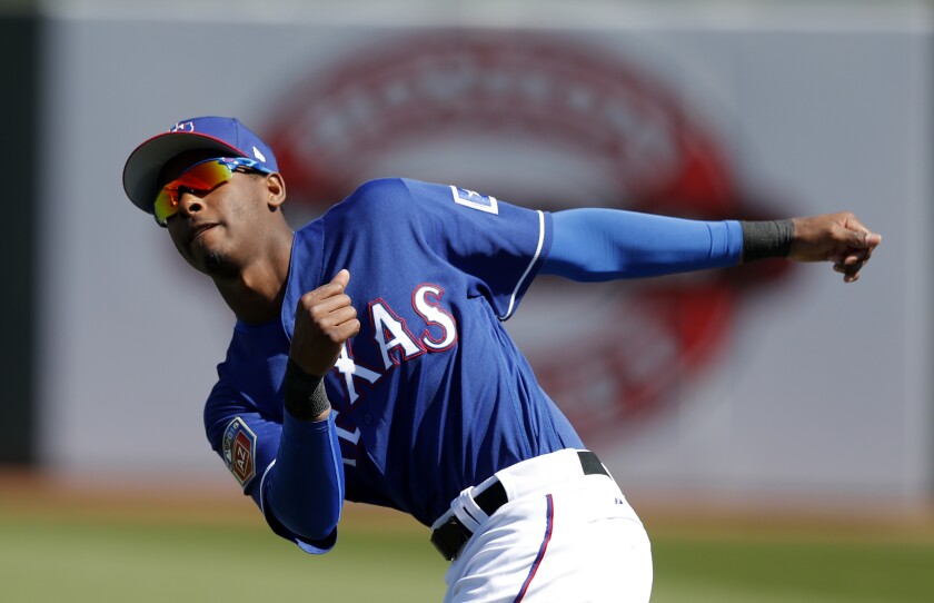 Brendon Davis stretches before of a spring training game between the Texas Rangers and San Diego Padres.