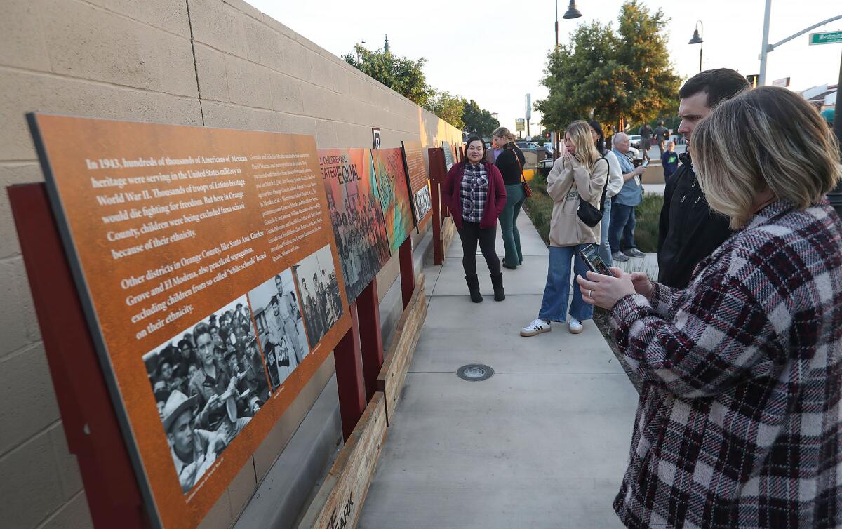 Vanguard teaching-credential students take in educational materials at Mendez Tribute Monument Park in Westminster.