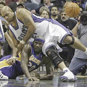 Laker Jumaine Jones collides with the Bucks' Marcus Fizer during the first half in Milwaukee.