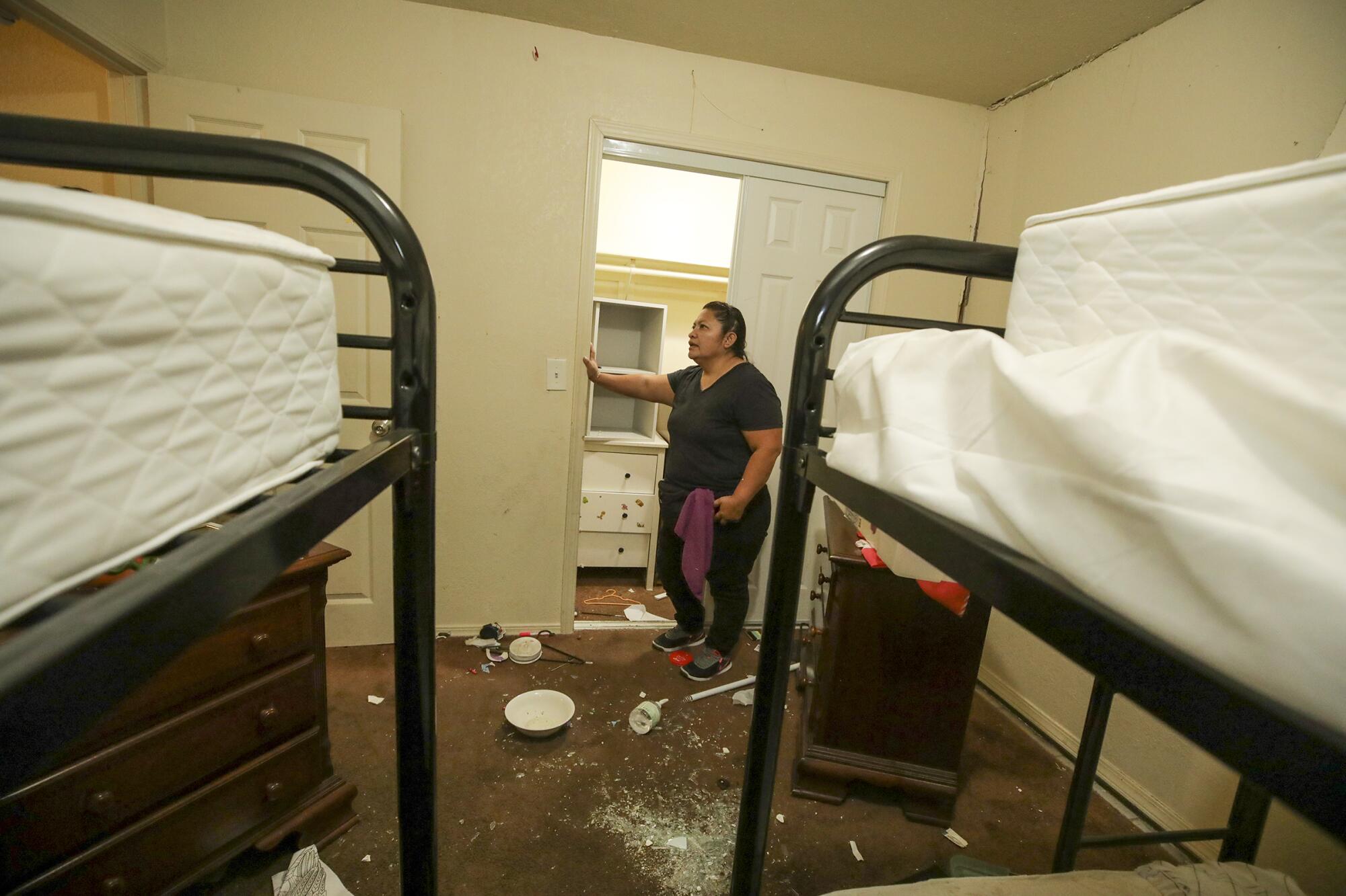 Juana Oceguera takes stock of her apartment that became inhabitable in an explosion caused by LAPD