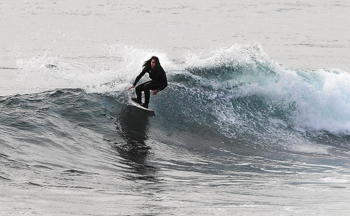 Alisa Schwarzstein, a pioneer in woman's pro surfing and member of Surfing Walk of Fame, surfs during a recent session in Laguna.