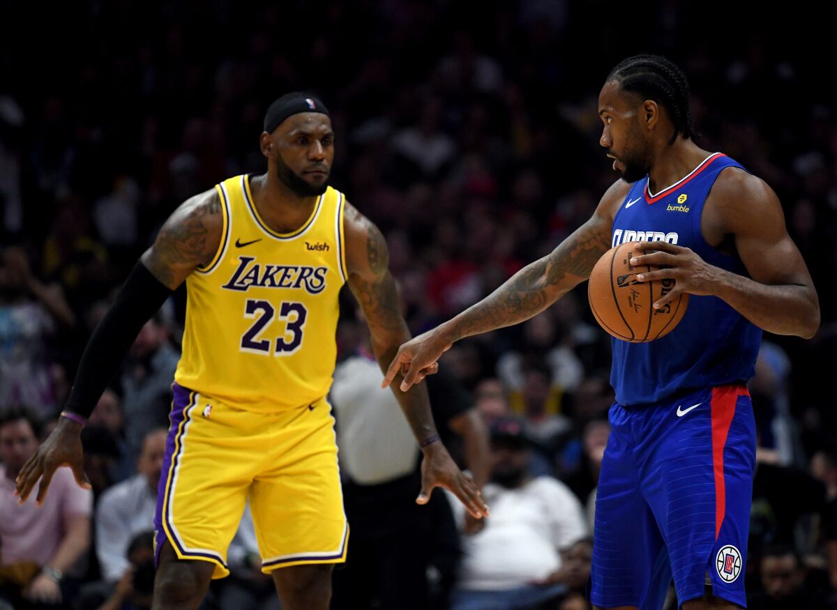 Forward Kawhi Leonard sets up the Clippers offense against LeBron James and the Lakers during the season opener. 