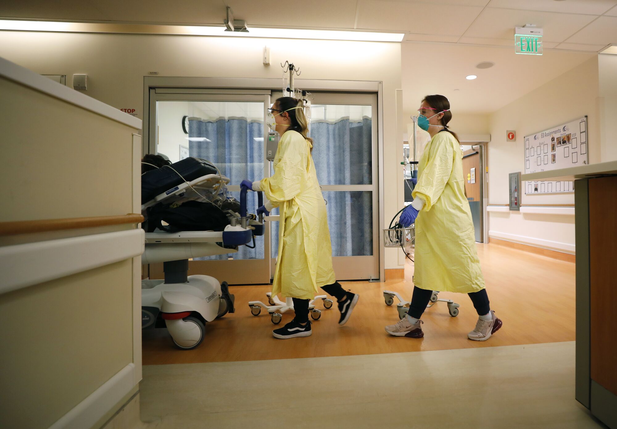 A COVID-19 patient is taken from the emergency room to the intensive care unit at Scripps Memorial Hospital La Jolla.