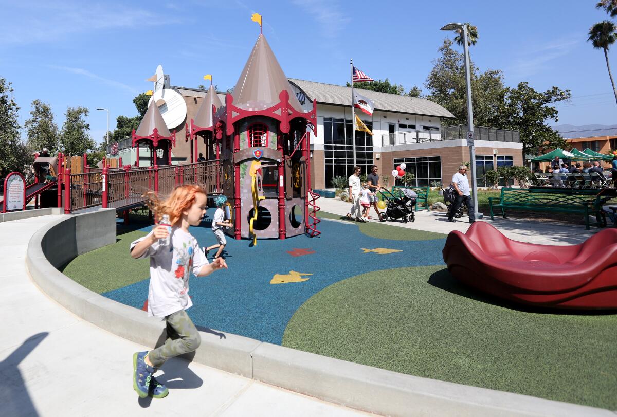 Children play on the new all-inclusive playground in Maple Park in south Glendale. Designed by the nonprofit Shane's Inspiration, the playground is intended to accommodate all children, no matter their abilities.