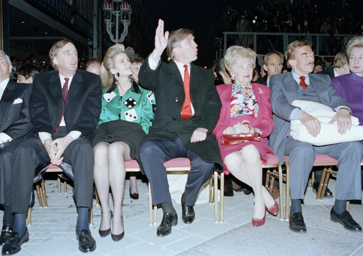 Donald Trump, seated with his mother, Mary, and father, Fred, waves to staff at the Trump Taj Mahal Casino Resort in 1990.