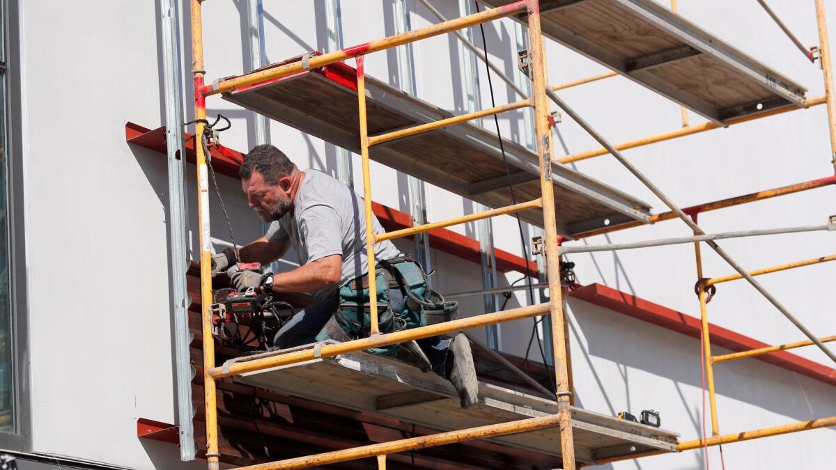 Marcos Ramirez "ERRE," installing "Of Fence" on the Oceanside Museum of Art.