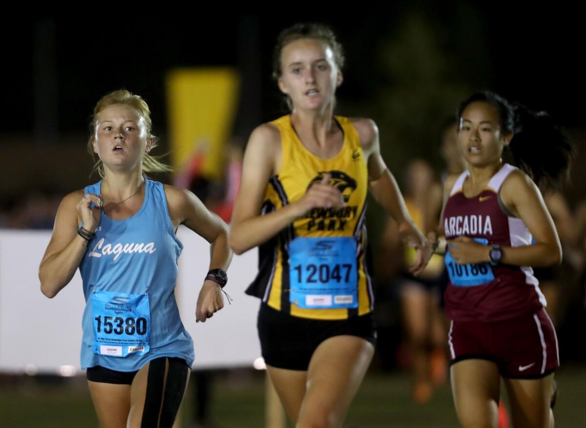 Laguna Beach's Hannah Konkel, left, competes in the sweepstakes race of the Woodbridge Invitational at SilverLakes Sports Park in Norco on Sept. 14, 2018.