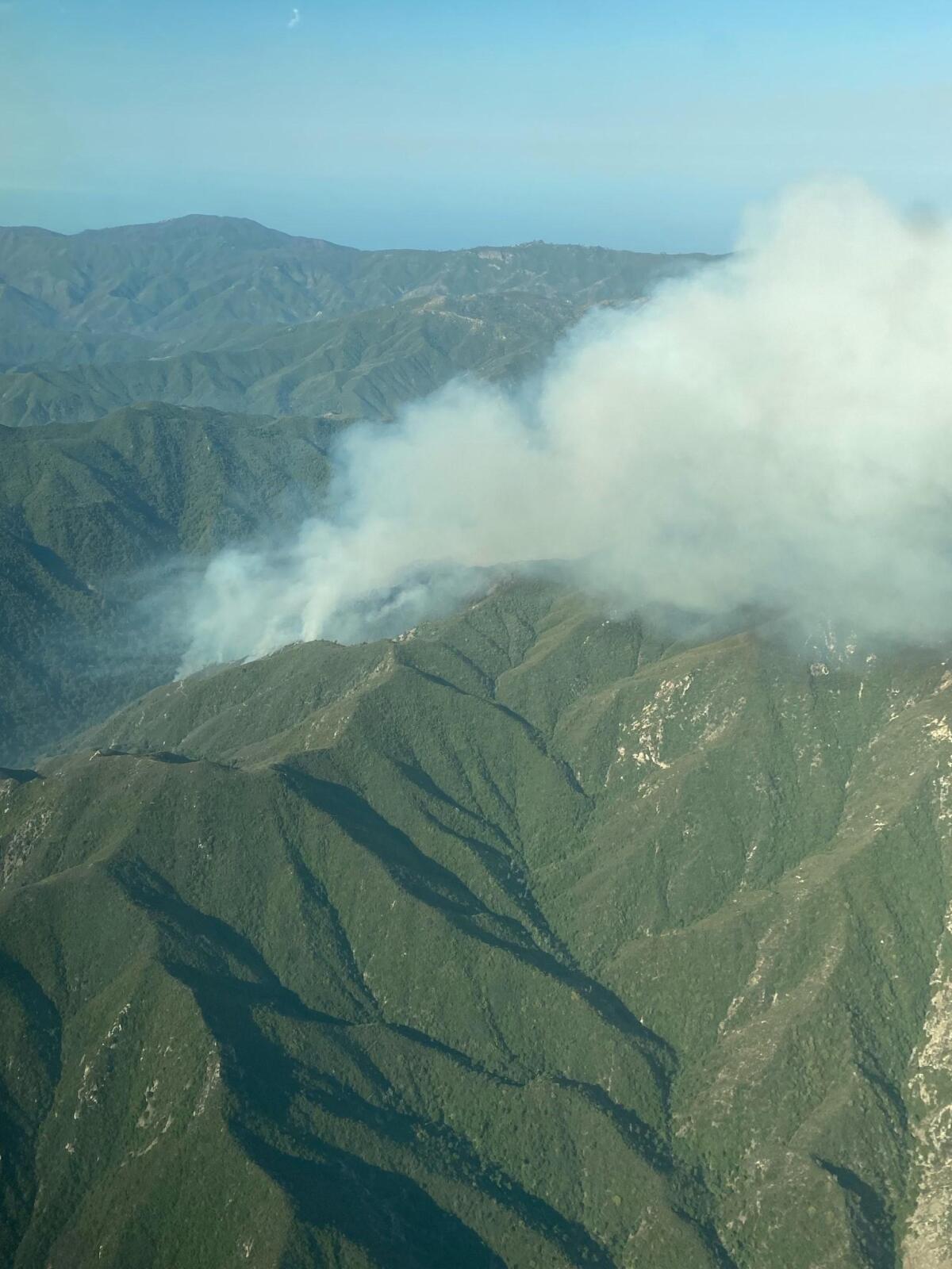 A plume of smoke hovers above the Los Padres National Forest.