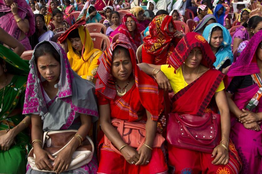 Indian tribal women in traditional attire listen to Congress party president Rahul Gandhi at an election campaign rally in Bokakhat, Assam, India, Wednesday, April 3, 2019. (AP Photo/Anupam Nath)