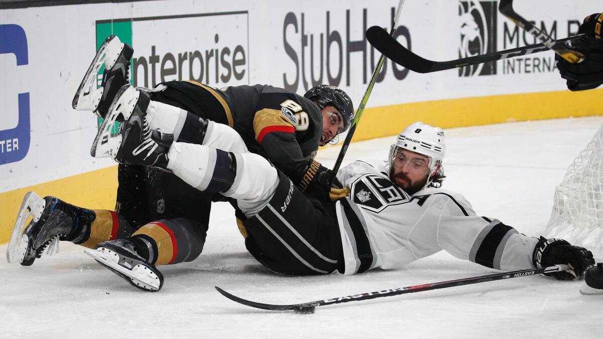 Kings defenseman Drew Doughty, right, and Las Vegas right wing Alex Tuch battle for the puck on Nov. 19.