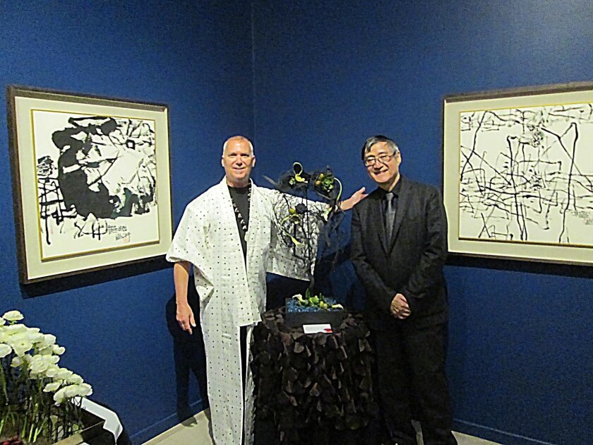 Inside, David Root poses with his interpretation of Pan Gongkai’s brush and ink painting ‘Lotus Pond’ and Pan Gongkai. ‘In my 25 years at Art Alive, this is the first time I got to meet a living artist!’ Root said.