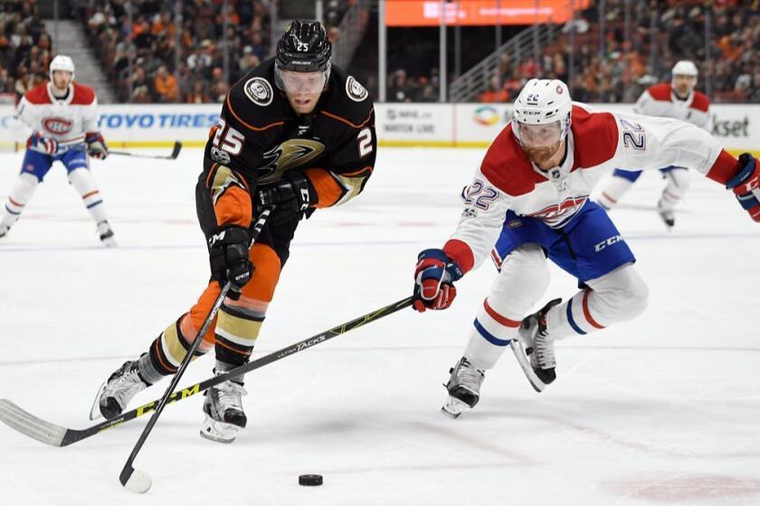 Anaheim Ducks right wing Ondrej Kase, left, of the Czech Republic, moves the puck as Montreal Canadiens defenseman Karl Alzner reaches in during the second period of and NHL hockey game, Friday, Oct. 20, 2017, in Anaheim, Calif. (AP Photo/Mark J. Terrill)