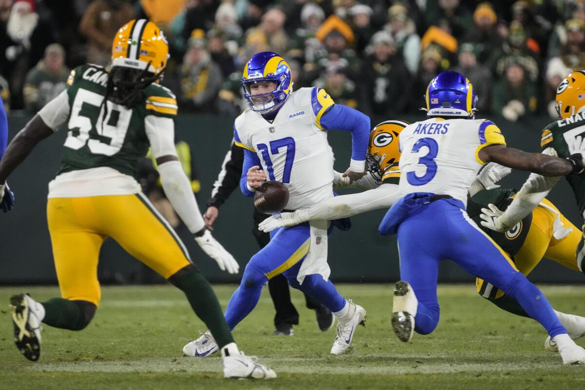 Rams quarterback Baker Mayfield (17) fumbles as he's hit by Green Bay Packers linebacker Quay Walker (7) in the first half. 