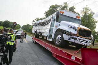 A bus is removed after it collied with a small pickup truck killing eight of the more than 50 migrant workers in the bus, Tuesday, May 14, 2024, in Ocala, Fla. The driver of the pick up, Bryan Maclean Howard, was charged with eight counts of DUI manslaughter. (AP Photo/Alan Youngblood)