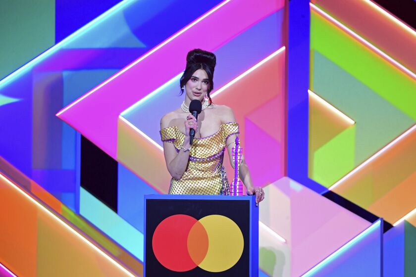 Dua Lipa accepts the award for Best Female Solo Artist during the Brit Awards 2021 at the O2 Arena, London, Tuesday, May 11, 2021. (Ian West/PA via AP)