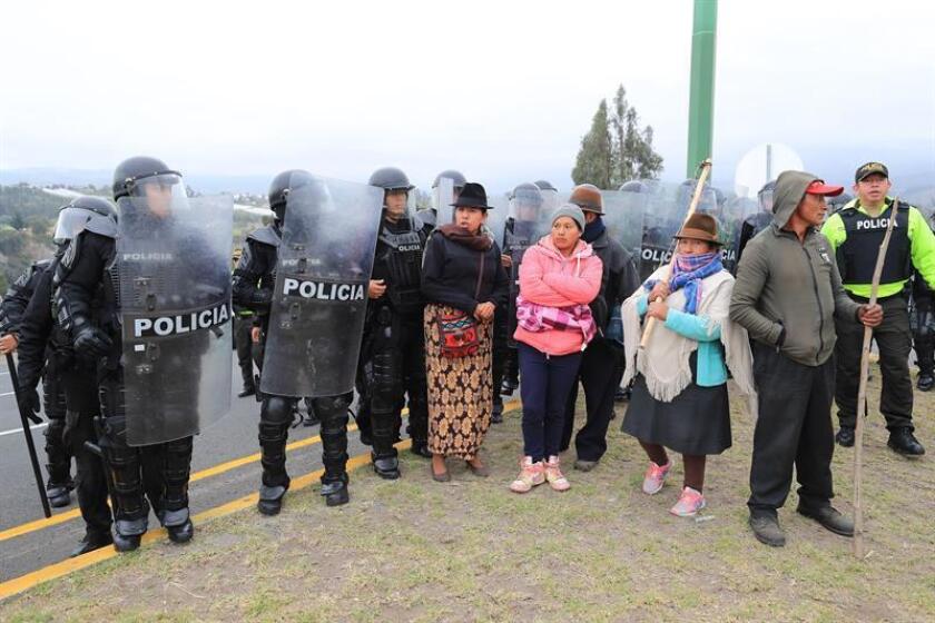 Policemen unblock a street blocked by members of the Confederation of Indigenous Nationalities of Ecuador (Conaie) as protest against the Ecuadoran Government's economic policies, in Panzaleo, Ecuador, Jan. 28, 2019. The Conaie has started a three-day-long protest against the recent economic policies taken by the Government, specially against the price rise of extra fuel. EPA-EFE/ Jose Jacome