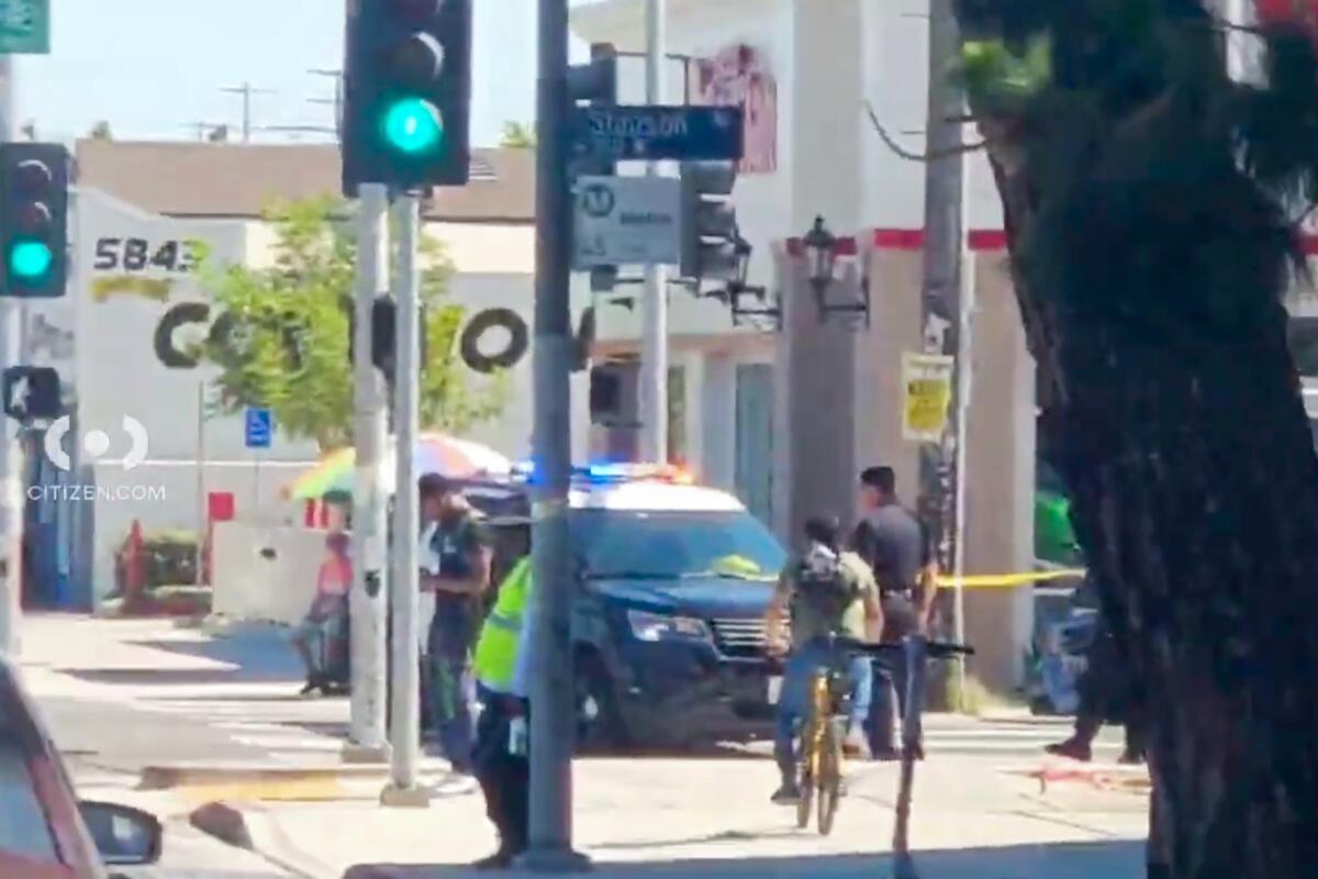 Police at the scene of the fatal stabbing of a man after he stepped off a Metro bus in South Los Angeles.