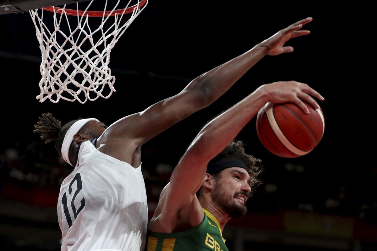 FILE - In this Sept. 9, 2019, file photo, Brazil's Anderson Varejao, right, keeps the ball from United States' Myles Turner during a match for the FIBA Basketball World Cup at the Shenzhen Bay Sports Center in Shenzhen. Varejao is expected to sign with the Cleveland Cavaliers for the remainder of the season after the NBA granted the team an injury exception hardship, a person familiar with the decisions told The Associated Press on Monday, May 3, 2021. (AP Photo/Ng Han Guan, File)
