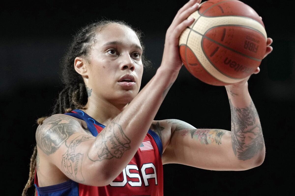 Brittney Griner holds the basketball preparing to shoot during a game