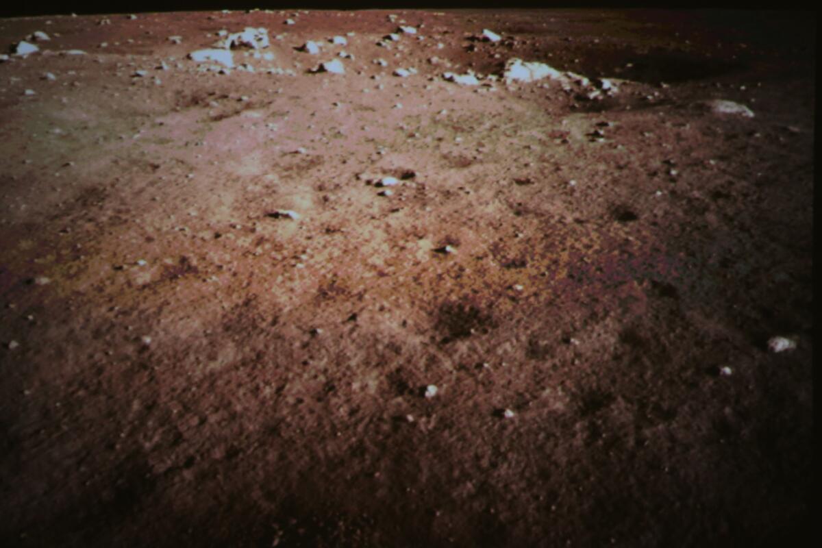 This Dec. 14, 2013 photo released by the official New China News Agency shows a picture of the moon surface taken by the on-board camera of the lunar probe Chang'e-3 on the screen of the Beijing Aerospace Control Center in Beijing.